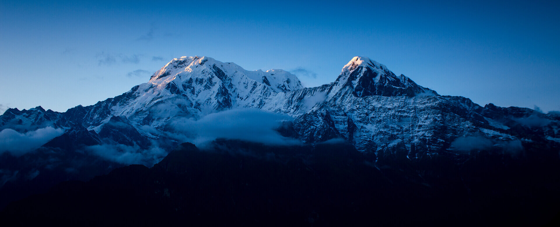Adventure hikers at sunrise on a mountain peak