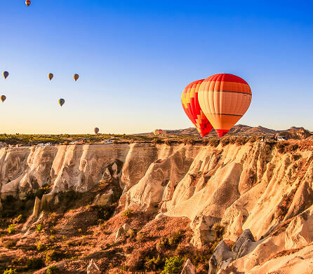 Hot air balloon over a rocky valley